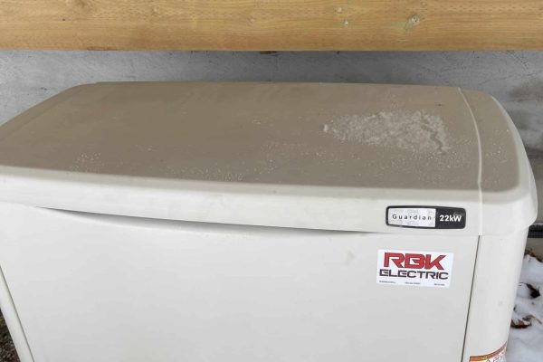 Generac standby generator on snowy ground